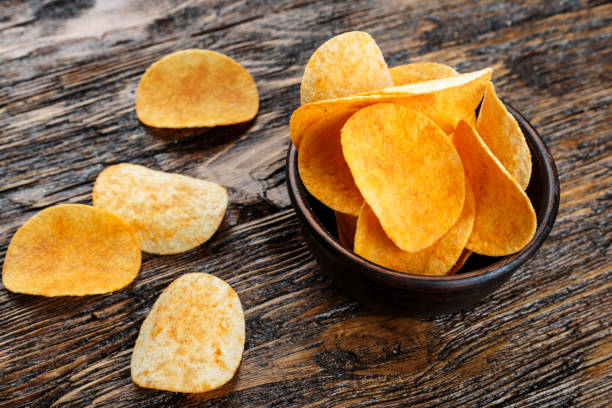 istock potato chips on wooden background. traditional beer snack. 1056738742