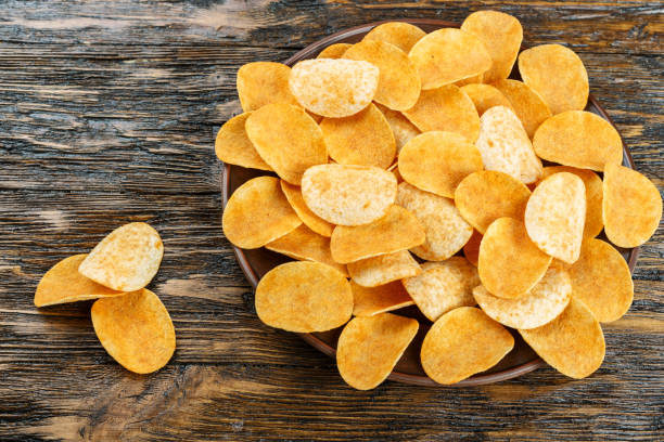 istock potato chips on wooden background. traditional beer snack. 1056738796