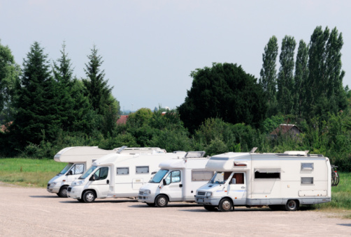 This photograph represent a row of trailer homes.