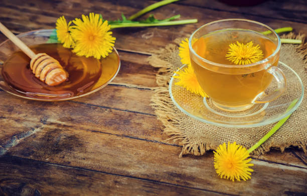 istock Honey from dandelion and a Cup of tea. Selective focus. 1056748802