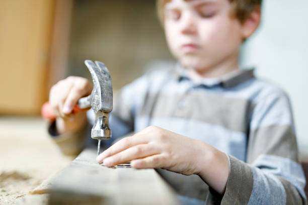 istock Little kid boy helping with toy tools on construciton site. 1056758744
