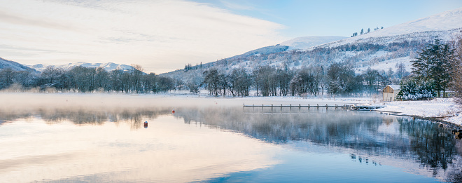 Mist rising from the water of Loch Earn in the Trossachs, Scotland.