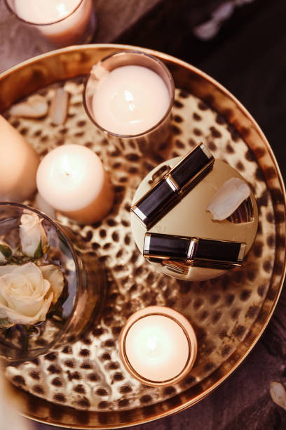 istock Cosmetics interior with lipstick, candles, rose petals 1056760506