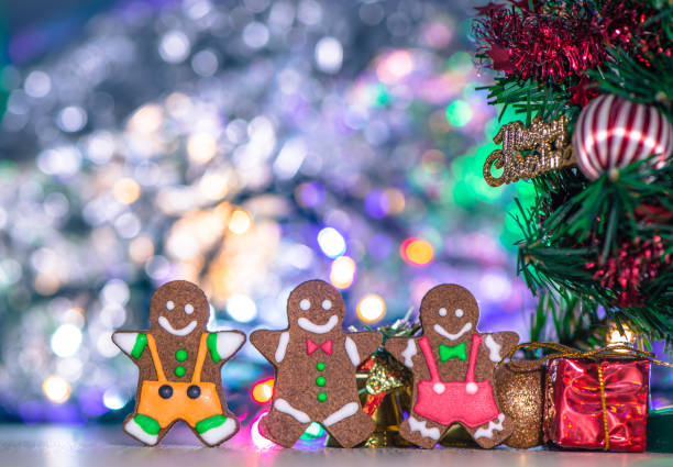istock Cute gingerbread man with christmas tree and blurry sparkle background, close up, bokeh, text space(copy space) 1056763134