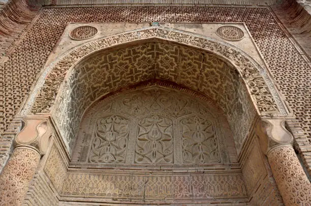 Mausoleum or gumbez,ancient tomb of Karakhanid 's dynasty covered with beautiful geometrical and floral muslim ornaments,located in Uzgen,Kyrgyzstan, silk road oldest towns,unesco heritage.