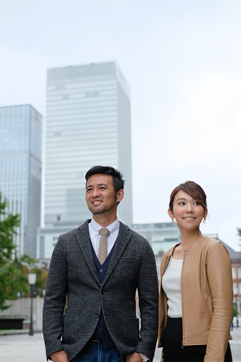 Businessman and businesswoman on the street of famous business district of Tokyo, Marunouchi