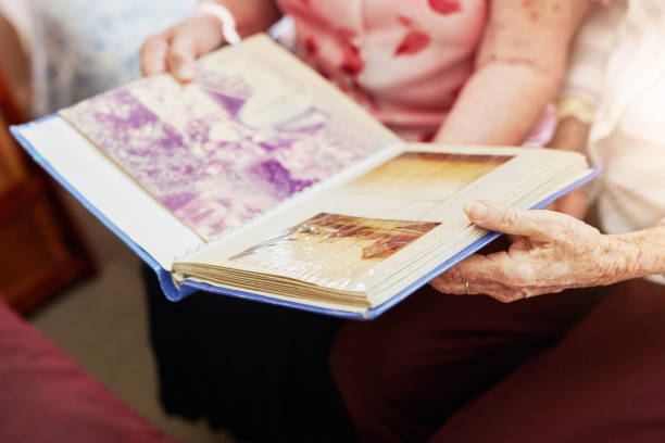 Cropped shot of two elderly women looking through a photo album together