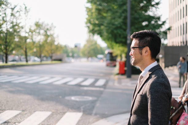 Businessman waiting in front of zebra crossing