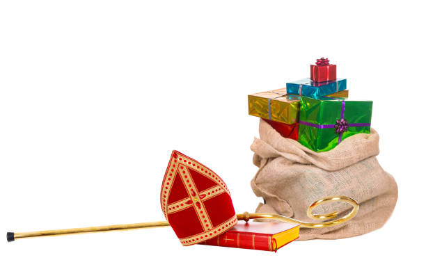 Mitre or miter and sack with gifts of saint nicholas. Dutch sinterklaas Mitre or miter sack with gifts and staff of saint nicholas. Isolated on white background. Sinterklaas border mijter stock pictures, royalty-free photos & images