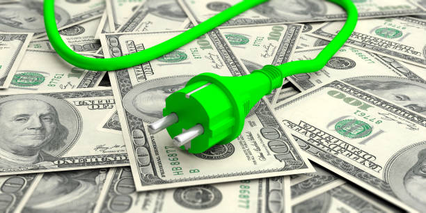 istock Green electric power plug on dollars banknotes. 3d illustration 1056779356