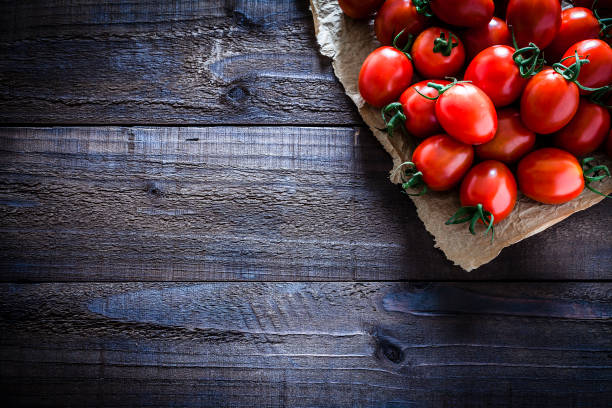 Fresh ripe tomatoes on crumpled brown paper still life