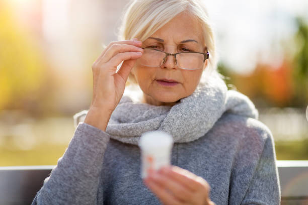 Senior woman checking label on medication