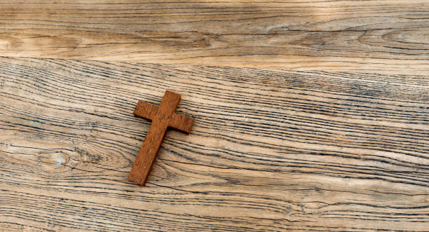 istock Wooden cross on desk background 1056790884