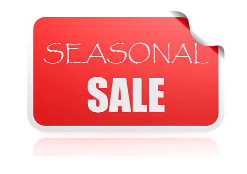 Sale sign over red Christmas bauble on red background. Horizontal composition with copy space. Front view. Great use for Christmas Sale concepts.