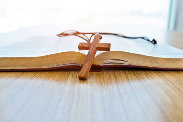 istock Bible and cross on wooden desk 1056793934