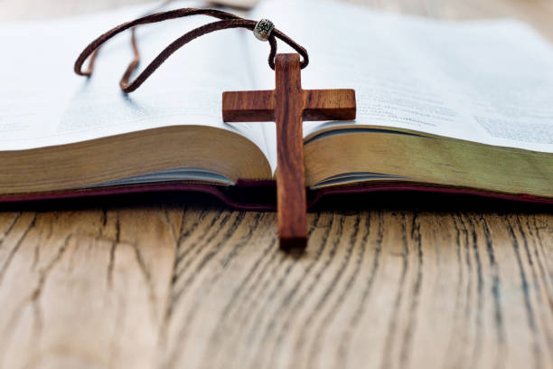 istock Bible and cross on wooden desk 1056793940