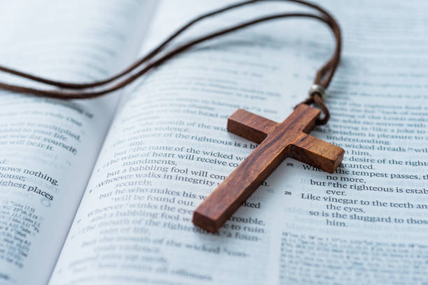 Bible and cross on wooden desk