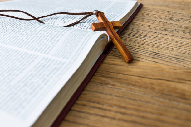 istock Bible and cross on wooden desk 1056794136