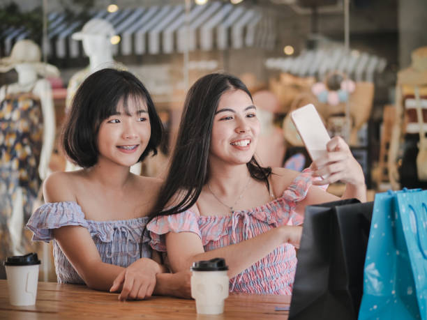 istock Happy Asian shoppers selfie together while drinking coffee, lifestyle concept. 1056796476