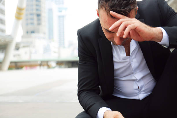 istock Businessman sitting sadness and thinking work on walking street. 1056796672