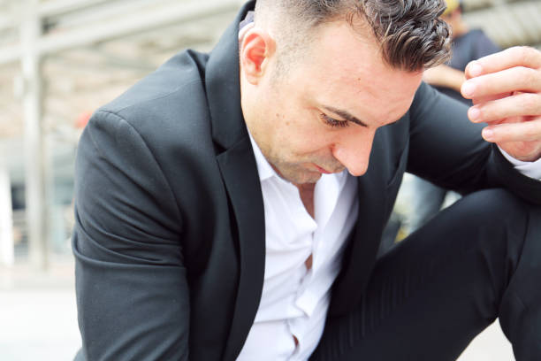 istock Businessman sitting sadness and thinking work on walking street. 1056796716
