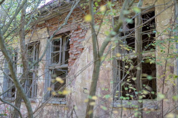 istock A broken window in an old abandoned building. Broken glass on the window site. Old building. 1056800310