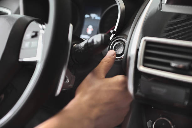 finger pressing the engine start stop button of a car - pushing push button human hand human finger imagens e fotografias de stock