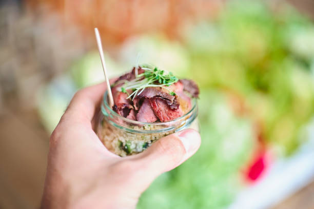 istock Man holding jar with delicious appetizers , close up. 1056803030