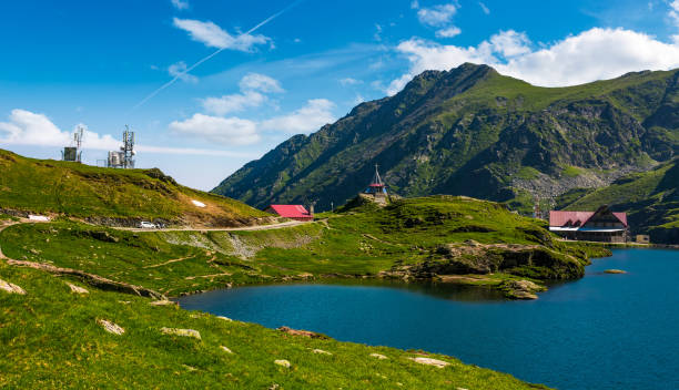 lake Balea in Fagaras mountains on a bright sunny day Transfagarasan road, Romania - Jun 26, 2017: lake Balea in Fagaras mountains on a bright sunny day. amazing summer landscape of one of the most visited landmarks in Romania balea lake romania stock pictures, royalty-free photos & images