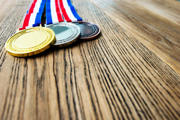 istock Three medals on wooden desk 1056804080