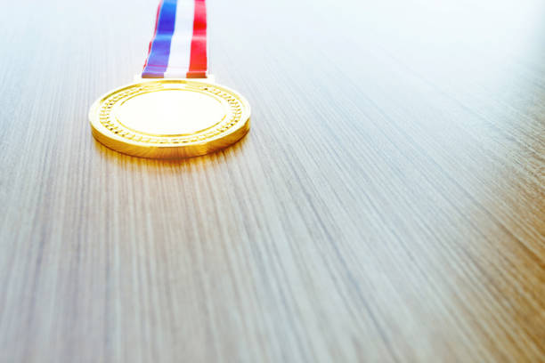 istock Gold medal on wooden desk 1056805196