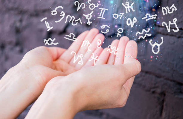 istock Hands and the flying zodiac signs 1056806502