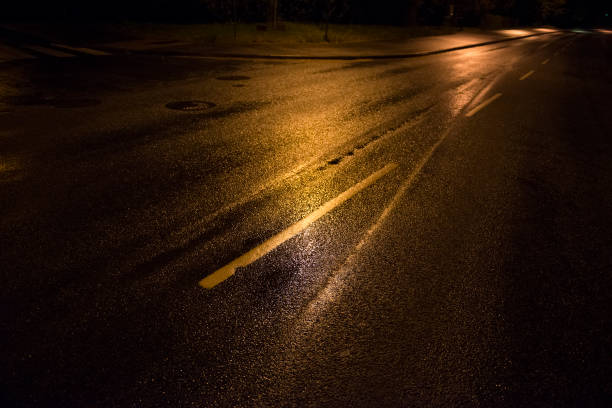 istock Yellow street lights and rain wait asphalt, lines, road 1056810372