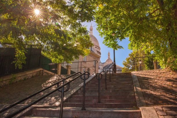 Montmartre staircase, Paris, France Typical sunny Montmartre staircase to Sacre-Coeur in the morning and sunlight coming through the trees, quarter Montmartre in Paris, France montmartre stock pictures, royalty-free photos & images