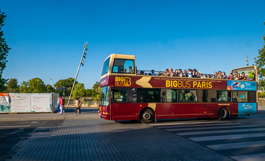 Paris, France - August 15, 2018 : Tourist enjoying open bus tour during sunny day of Paris