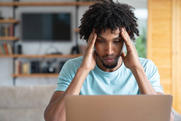 istock Thoughtful worried man working online at home 1056814272