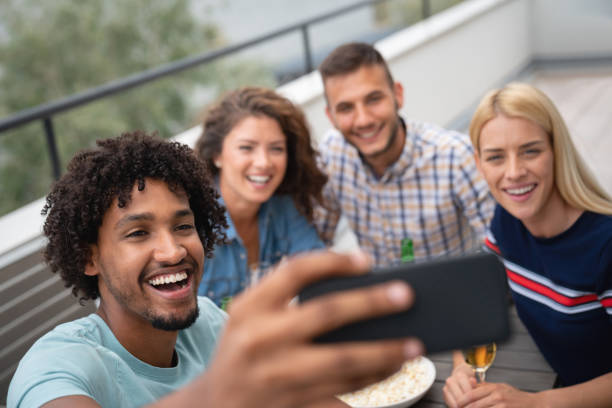istock Group of house mates outdoors at home taking a selfie 1056814334