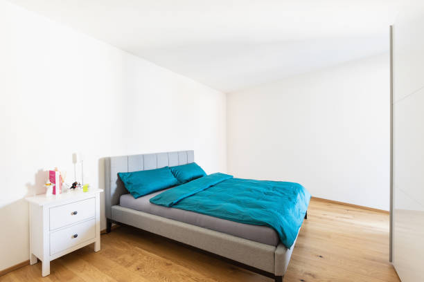 istock Modern bedroom with turquoise cover and parquet. 1056817850
