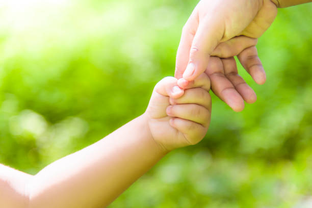 istock Mother is holding hands with boy boy in the wild 1056823706