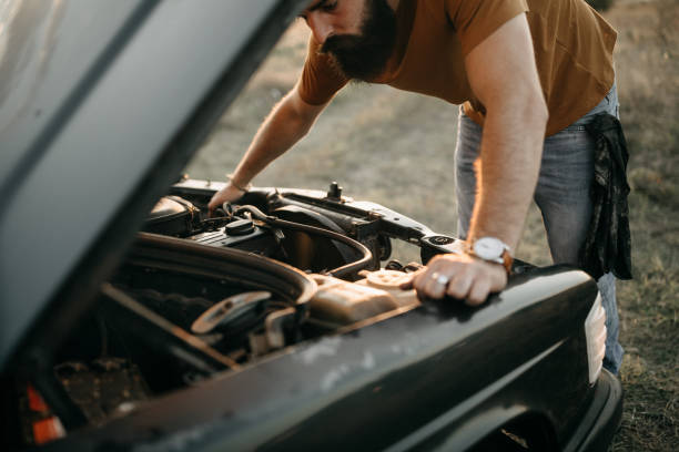 What's now?! Photo of young man is fixing his car bonnet hat stock pictures, royalty-free photos & images