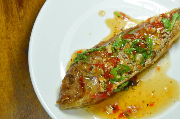 istock crispy fried sharp tooth snapper dressing with sweet chili sauce 1056826646