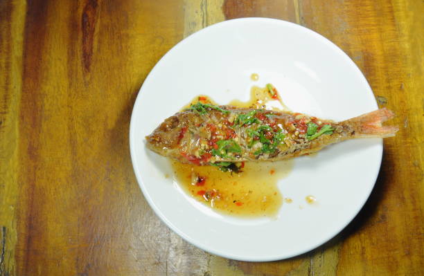 istock crispy fried sharp tooth snapper dressing with sweet chili sauce 1056826914
