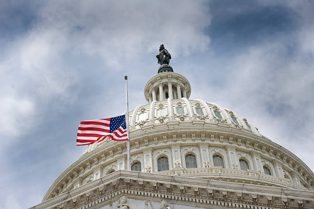 American flag over U.S. Capitol An American flag flies at half mast over U.S. Capitol Building. half mast national flag american flag washington dc stock pictures, royalty-free photos & images