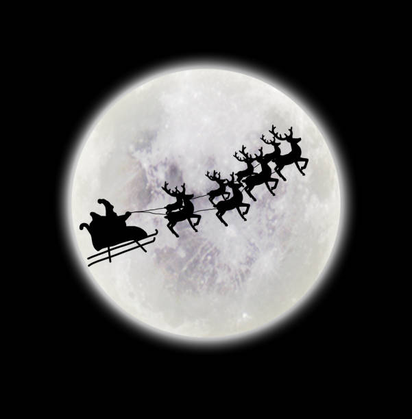 istock Santa riding sleigh with reindeers silhouette 1056832690