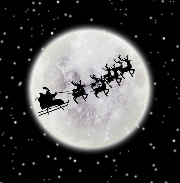 istock Santa riding sleigh with reindeers silhouette 1056832702