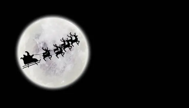 Photo of Santa riding sleigh with reindeers silhouette