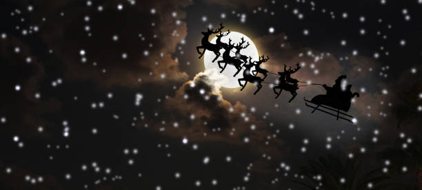 istock Santa riding sleigh with reindeers silhouette 1056832772