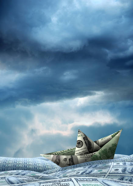 Conceptual one hundred dollar paper boat on money covered landscape over cloudy sky Conceptual American one hundred dollar paper boat on money covered landscape over cloudy storm sky making money origami stock pictures, royalty-free photos & images