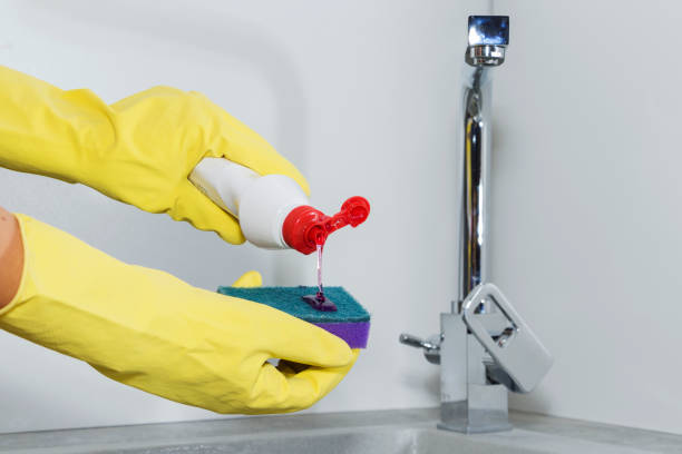 istock female hands close-up, wash the dishes in the kitchen. 1056834986