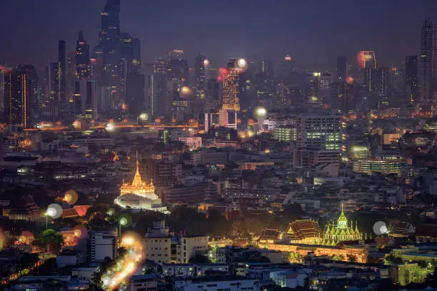 Photo of Golden mountain in Wat Saket Ratcha Wora Maha Wihan and Lohaprasat in Wat Ratchanatdaram Worawihan which is landmar in Bangkok, Thailand with bangkok cityscape background.